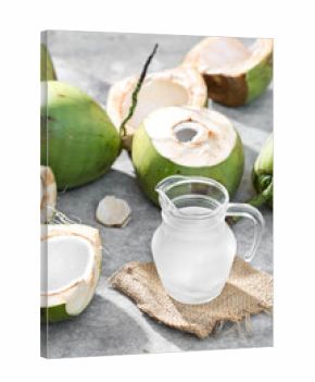 Fresh Coconut Water in Glass Jug with Open Coconut Shells