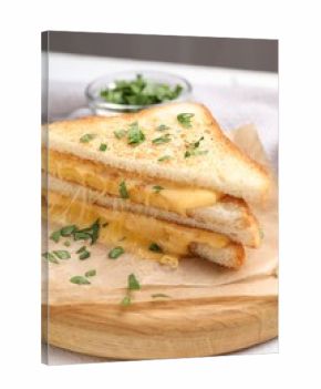 Delicious sandwiches with melted cheese and parsley on white table, closeup