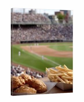 Hands showcase delicious chicken wings, crispy fries, and beer in cups while fans cheer in a vibrant baseball stadium atmosphere