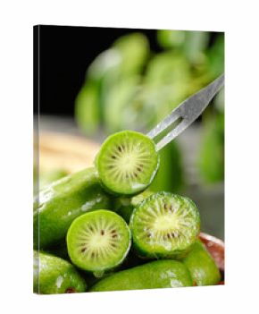 Fresh Mini Kiwi Berries with Water Droplets - Healthy Exotic Fruit Sliced on Fork