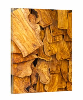 Olive wood chopping boards hanging in a store creating a beautiful pattern