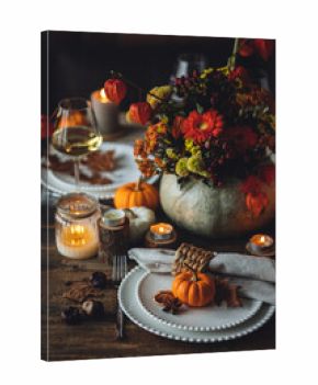 Atmospheric autumn elegant beautiful table setting with pumpkins for a wedding or thanksgiving family celebration. Fall decoration countryside rustic style, cozy home atmosphere , candles, wine