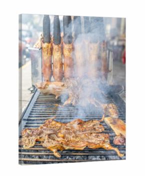 Typical food of Ecuador: guinea pig roasting on the grill, prepared with traditional Andean techniques that preserve cultural essence and offer a unique gastronomic experience.