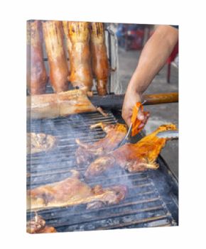 Typical food of Ecuador: guinea pig roasting on the grill, prepared with traditional Andean techniques that preserve cultural essence and offer a unique gastronomic experience.
