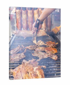 Typical food of Ecuador: guinea pig roasting on the grill, prepared with traditional Andean techniques that preserve cultural essence and offer a unique gastronomic experience.
