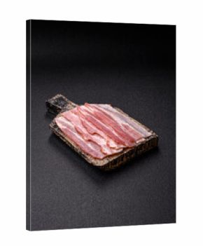 Raw or smoked pork bacon slices or strips as a breakfast ingredient. Raw bacon