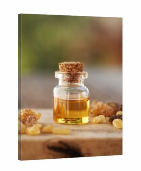 A bottle of frankincense essential oil with frankincense resin