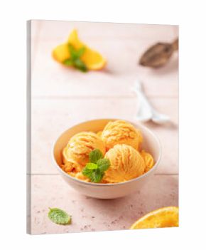 Natural fruit orange ice cream or sorbet in ceramic bowl