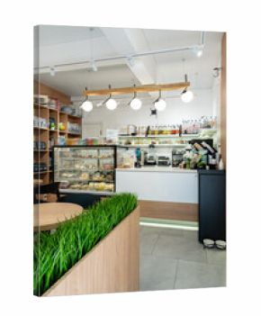 Bright and modern cafe interior with a display of baked goods and coffee brewing station