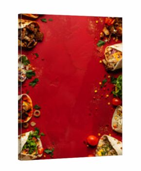 Mixed shawarma wraps with vegetables and spices arranged on a textured red background, top-view food frame. Restaurant ads, delivery services, social media food content.