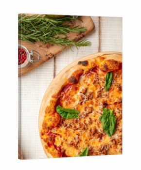 Hot fresh baked pizza topped with melted cheese tomato sauce minced meat and basil leaves on board