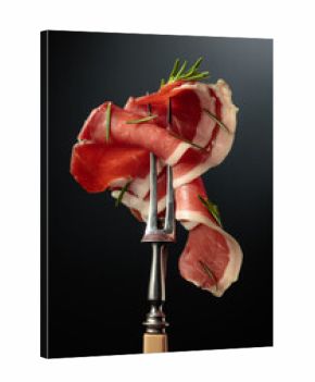 Sliced prosciutto with rosemary.