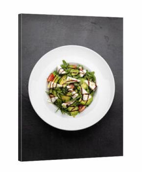 Fresh avocado and feta salad with arugula, cherry tomatoes and balsamic drizzle