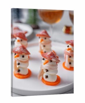 Mozzarella balls with sausage, bacon and carrot slices in the form of snowman for Christmas holidays