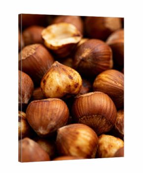 Roasted hazelnuts scattered on a wooden surface create a warm and inviting sight for snack lovers