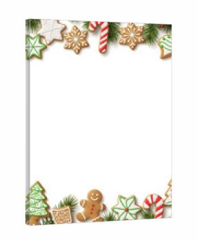 Festive Christmas border made of decorated gingerbread cookies and fir branches on a white background.