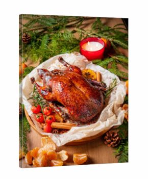 Roasted duck rests on herbs with citrus and candles, creating a warm atmosphere