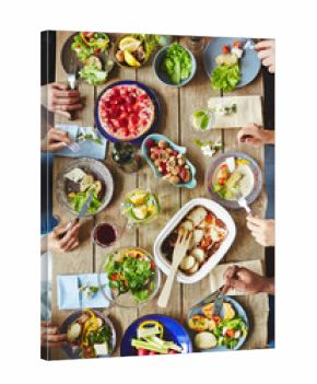Hands of buddies eating vegetarian food by dinner