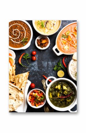 Assorted indian food for lunch or dinner, rice, lentils, paneer, dal makhani, naan, chutney, spices over moody background. selective focus  
