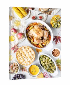 Thanksgiving dinner with chicken, apple pie, pumpkin soup brussel sprouts and fruits.