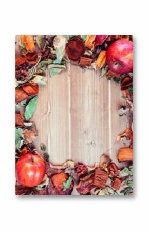 Apples with dry leaves on table