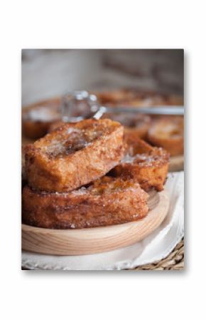 French toasts on a wooden plate.