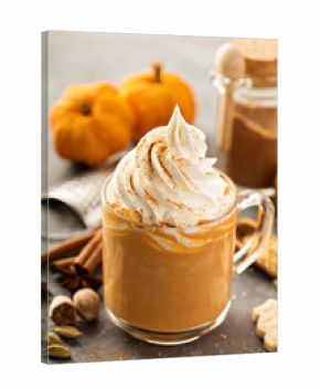 Pumpkin spice latte in a glass mug