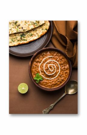 Dal makhani or dal makhni is a popular food from Punjab / India made using  whole black lentil, red kidney beans, butter and cream and served with garlic naan or Indian bread or roti    