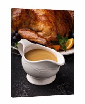 Homemade gravy in a sauce dish with turkey