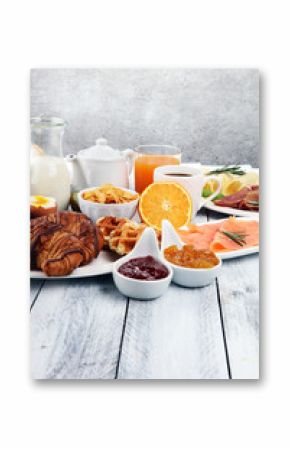breakfast on table with waffles, croissants, coffe and juice
