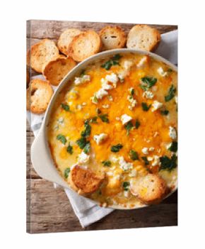 chicken buffalo dip with blue cheese and greens close-up in a baking dish. vertical top view