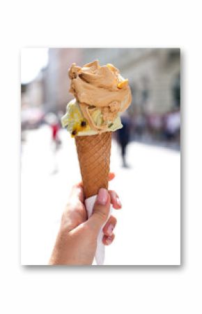 melting delicious ice cream in waffle cone gelato pistachio salty caramel holding female hand