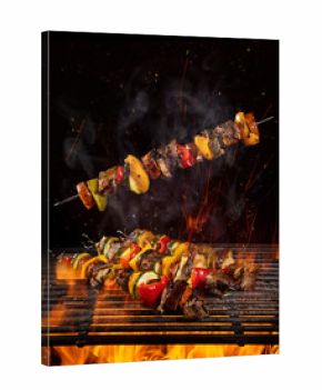 Tasty skewers on the grill with flames