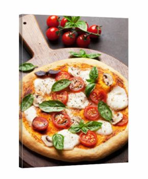 Italian pizza with tomatoes, mozzarella and basil