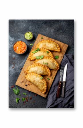 Latin American fried empanadas with tomato and avocado sauces. Top view