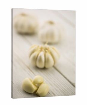 Garlic cloves and bulb on wooden surface