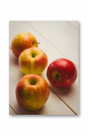 Fresh red apples on wooden table