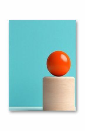 Orange Sphere on Wooden Cylinder Against Light Blue Background