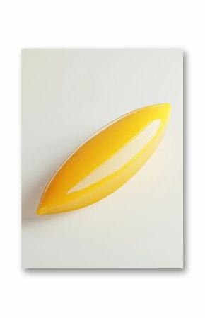 A smooth, oblong, glossy, vibrant yellow object.  Its shape is elongated and slightly tapered, with a reflective surface. The interior appears lighter, creating a subtle gradient