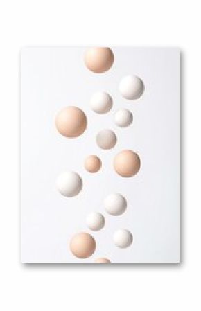 Floating Cream and Beige Spheres in a Staggered Grid on White Background