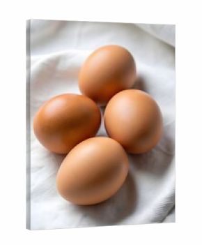 3d icon of four brown chicken eggs arranged on a textured white fabric, showcasing their smooth shells and natural appearance