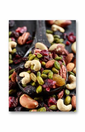 Nuts and dried fruits mix on wooden spoon