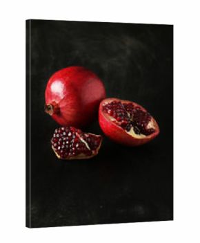 Delicious pomegranate fruit on black background