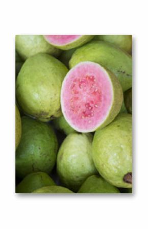 Fresh ripe guava fruit cut open to display the pink flesh at a farmers market in Rio de Janeiro, Brazil