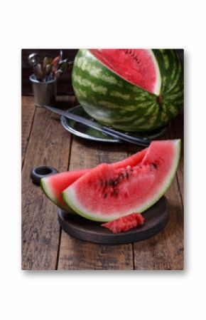 Sliced ripe watermelon on brown wooden table.