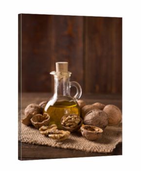 Walnut oil and nuts on wooden table