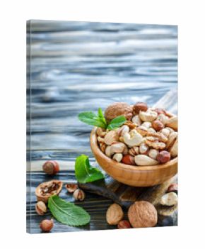 Assorted nuts in a wooden bowl.
