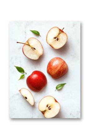 Apples flat lay on a marble background. Group of sliced and whole apple fruits viewed from above. Top view