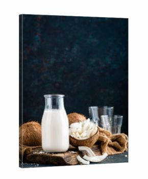 Fresh coconut milk in glass bottle, vegan non dairy healthy drink