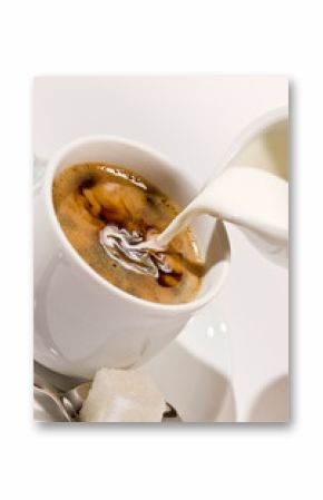 Puring milk in a cup of coffee